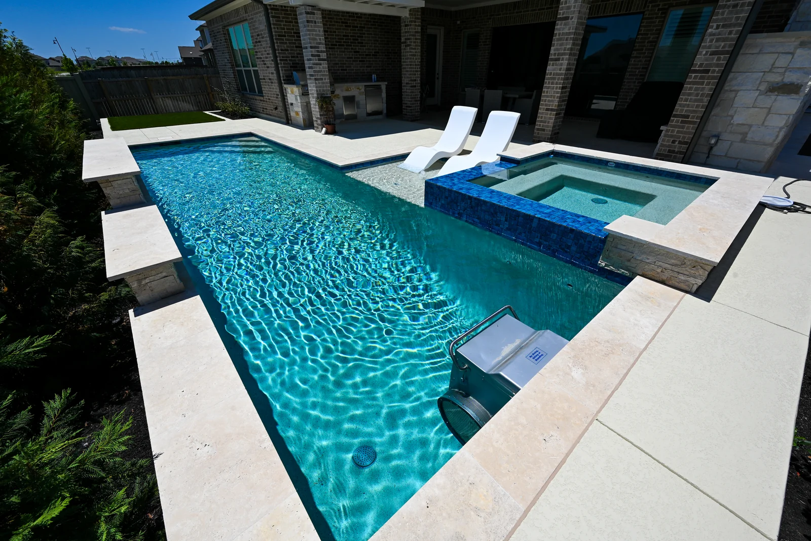 Swimming pool photographed down its long axis toward the spa