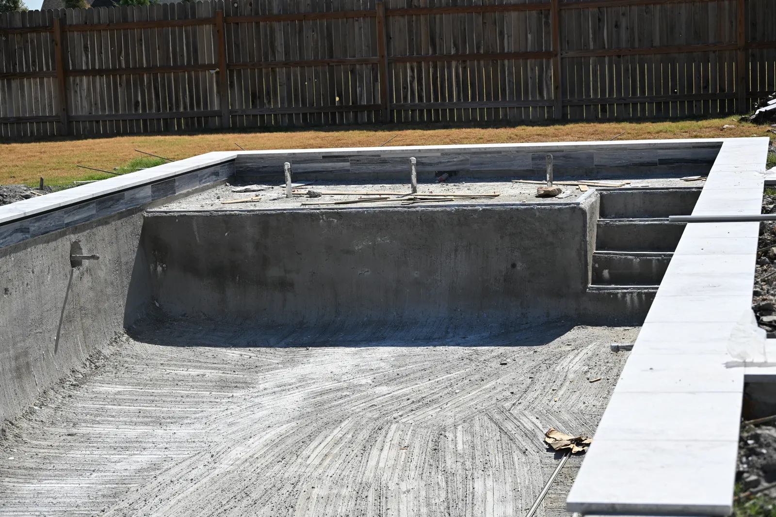 Gunite shell showing the entry steps and bench before finishing