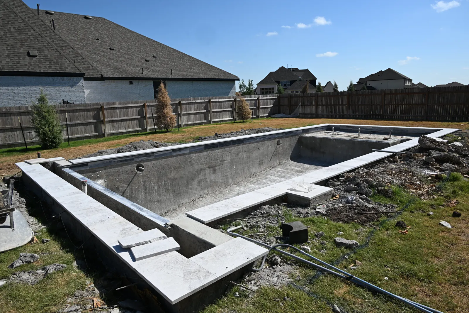 Cured gunite pool shell with raised bond beam, before tile and plaster