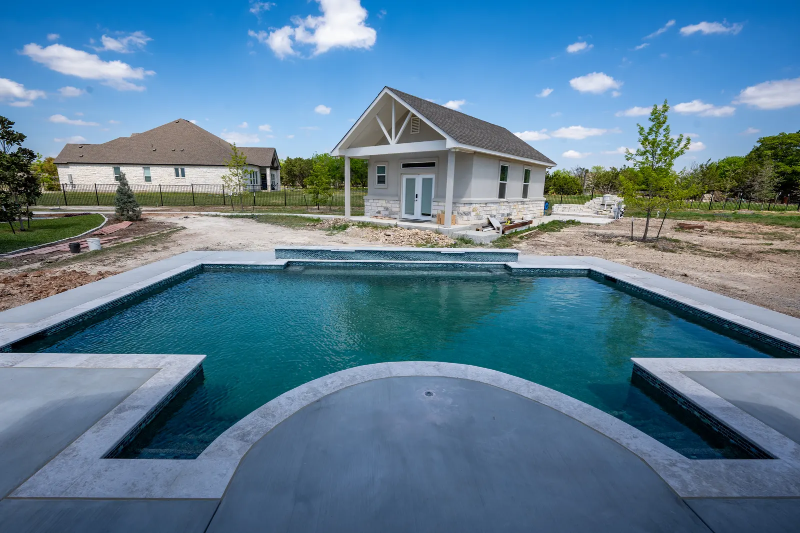 Geometric pool with a wide sun shelf at the near end