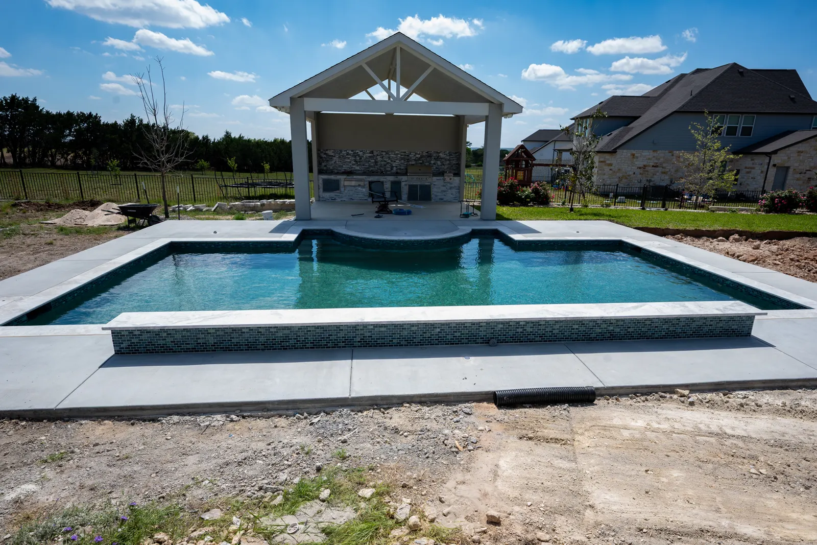 Trinity Pool Construction — a finished pool and cabana in Central Texas