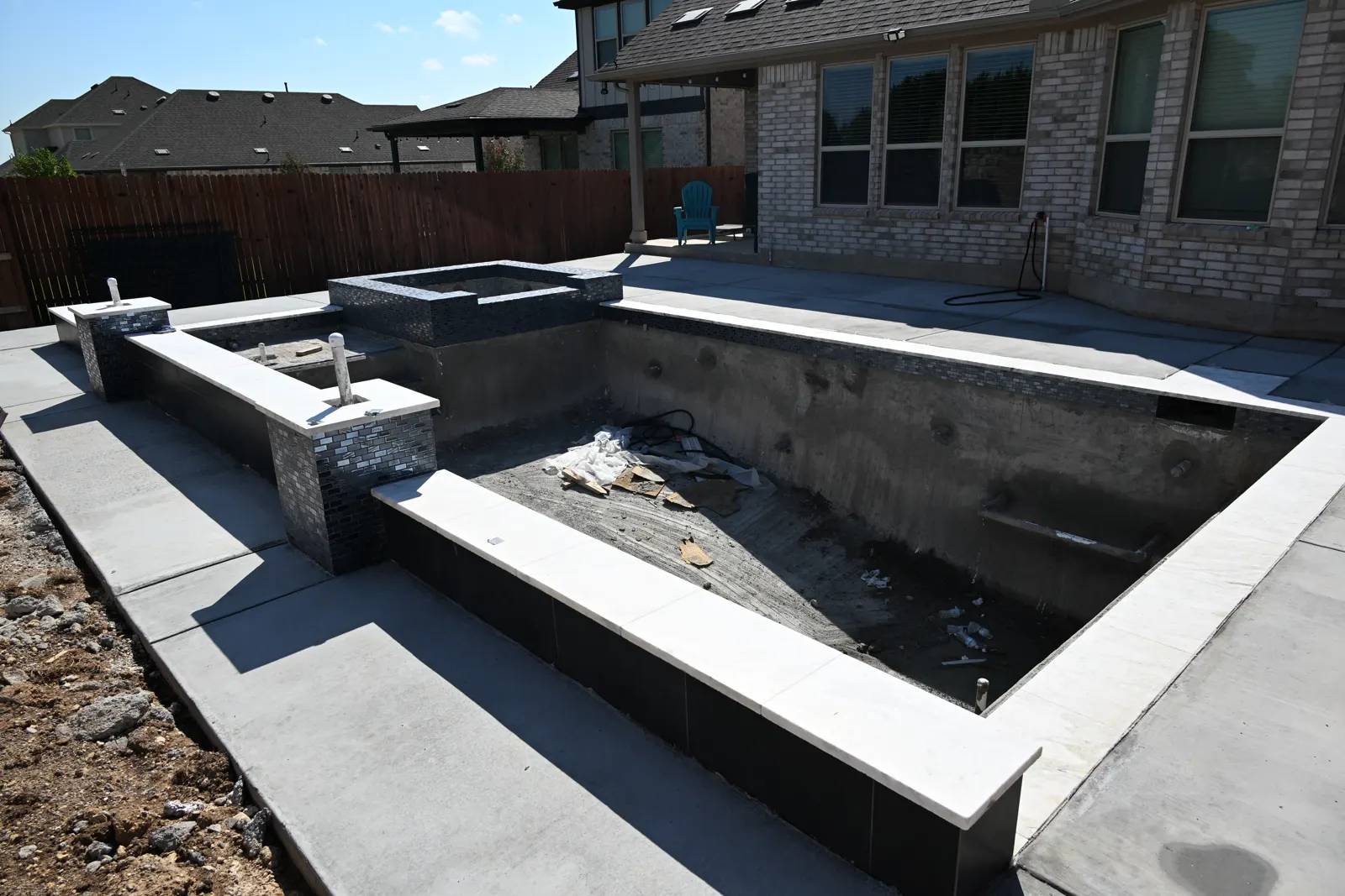 Rectangular shell with a raised tiled wall and spa, deck poured